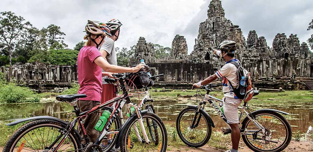 Couple cycling in Angkor