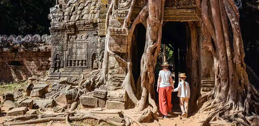 Family visiting Ta Phrom Temple