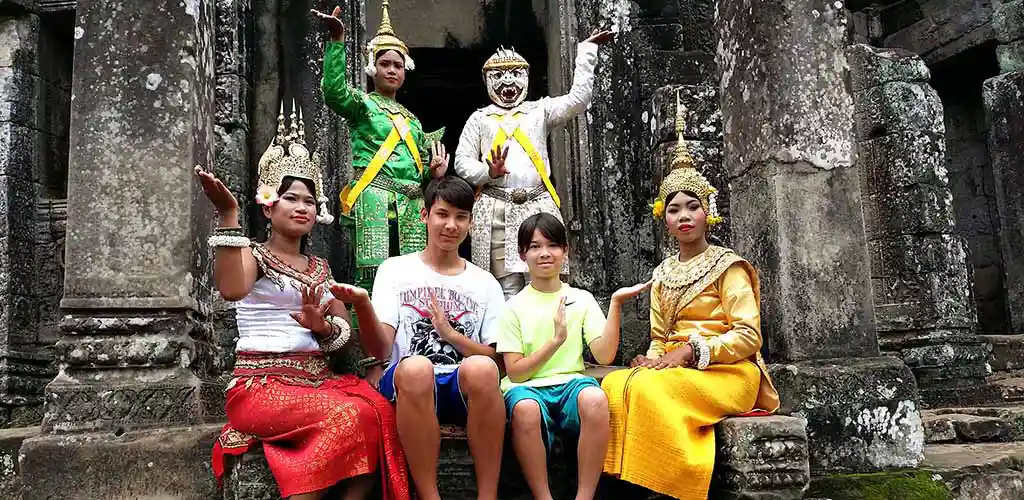 Family with Khmer dancers in Angkor, Cambodia