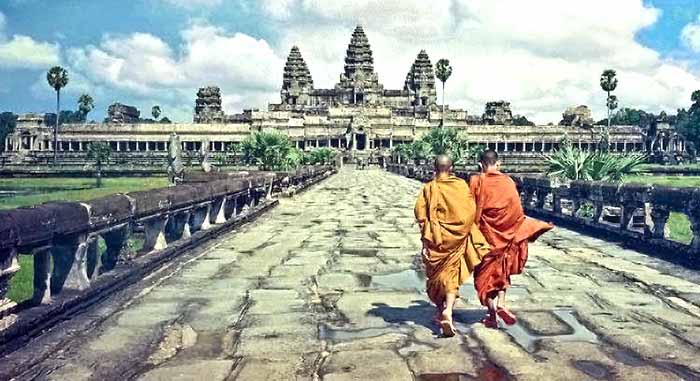 Monks walking towards Angkor Wat in Cambodia