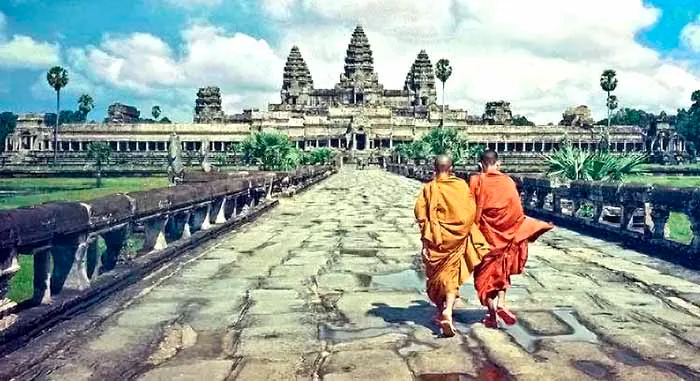 Monks walking the causeway in front of Angkor Wat, Cambodia