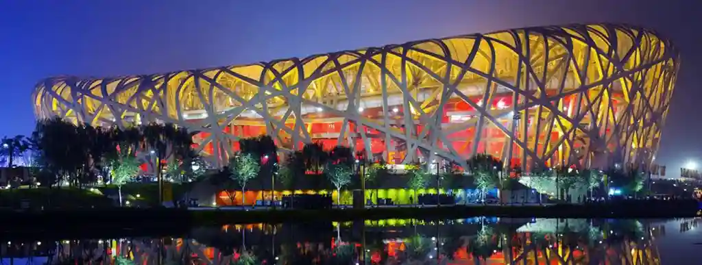 Beijing National Stadium (Bird's Nest) lit up at night.