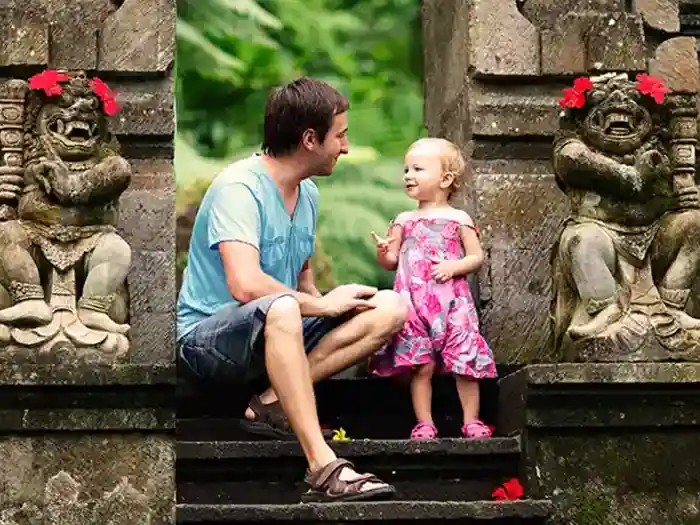 Father with young daughter tourists at temple in Bali, Indonesia