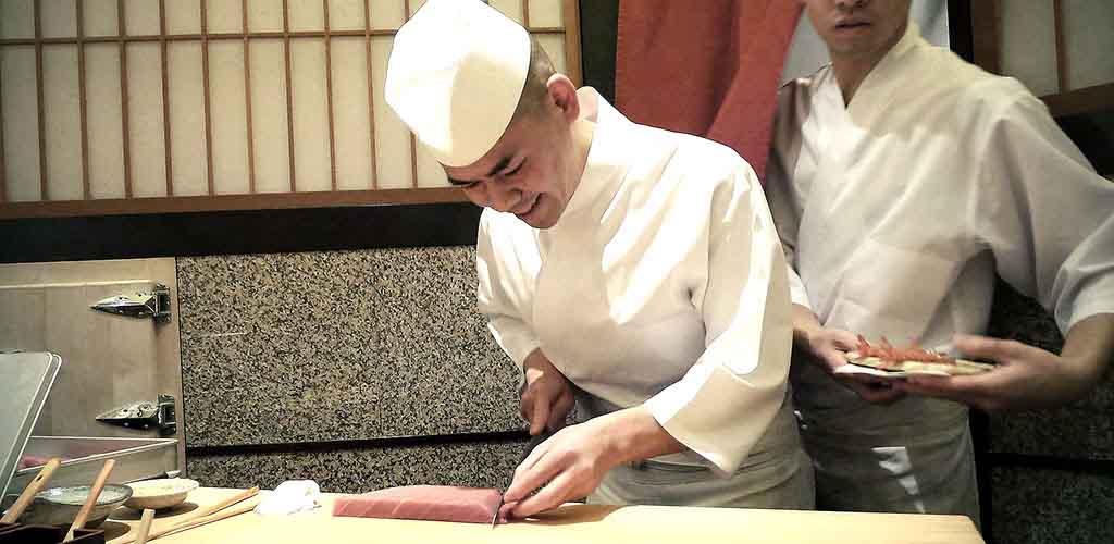 Chef cutting sashimi at Sushi Saito in Tokyo, Japan 