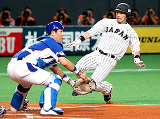 Tokyo Giants baseball player sliding into home plate