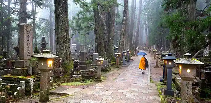 Monk walking through the Okunoin cemetary in Koyasan, Japan