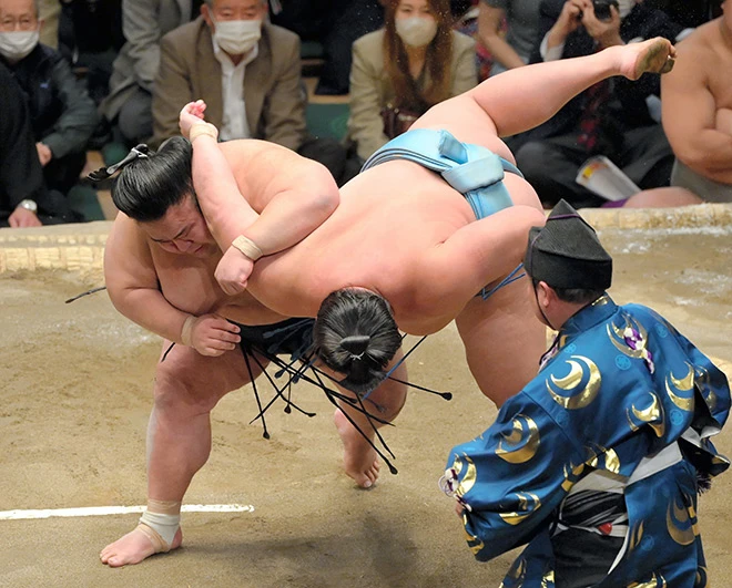 Sumo fighter throwing opponent in Tokyo, Japan