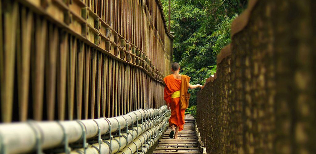Monk on bamboo bridge, Luang Prabang, Laos