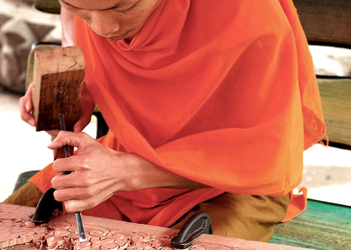 Monk wood carver in Laos