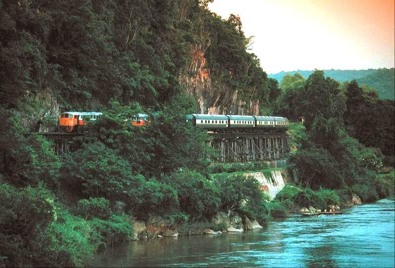 Eastern Orient Express luxury train passing by river in Thailand