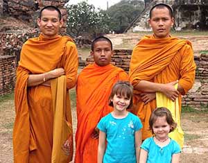 Posing with monks during family tour of Thailand