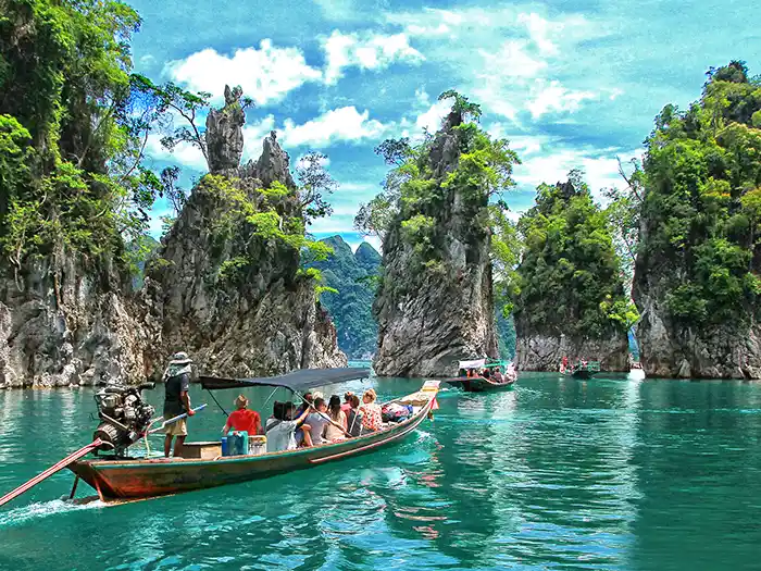 Cruising karst islands in Southern Thailand by longtail boat.