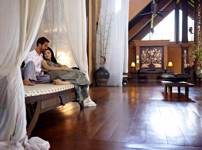 Honeymoon couple on daybed in Thailand resort
