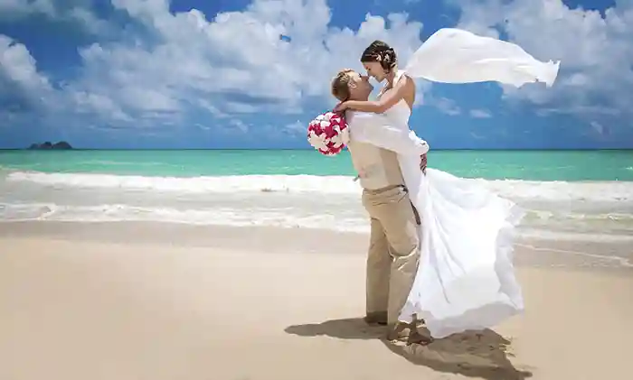 Honeymoon couple posing for photos on beach in Phuket, Thailand