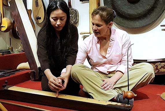Learning to play the traditional Vietnamese instrument, dan bau, in Hanoi, Vietnam