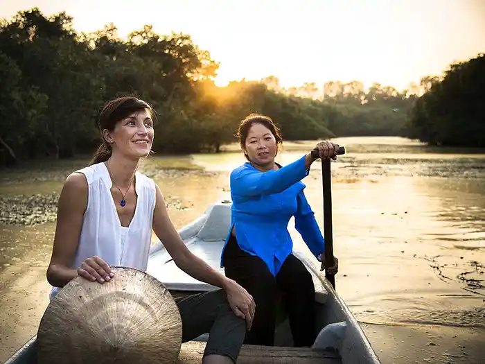Traveler rowing in a sampan along the Mekong in Chau Doc, Vietnam