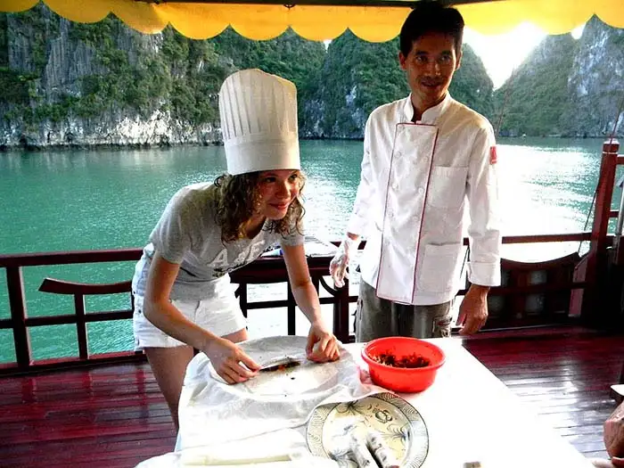 Learning to cook spring rolls on Halong Bay, Vietnam