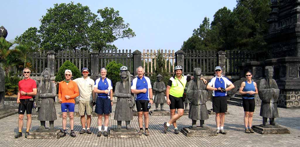 Cycling tour group at Tu Duc Royal Tomb in Hue, Vietnam
