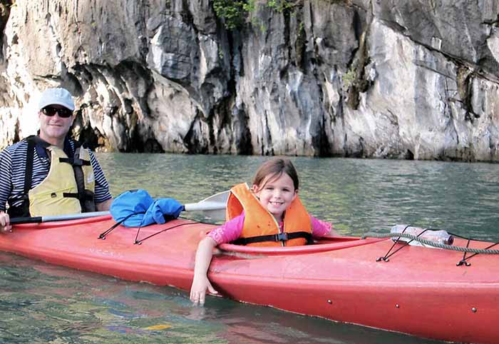 Family kayaking on Halong Bay, Vietnam