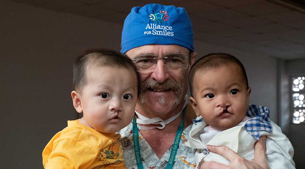 Doctor at Alliance for Smiles nonprofit with children